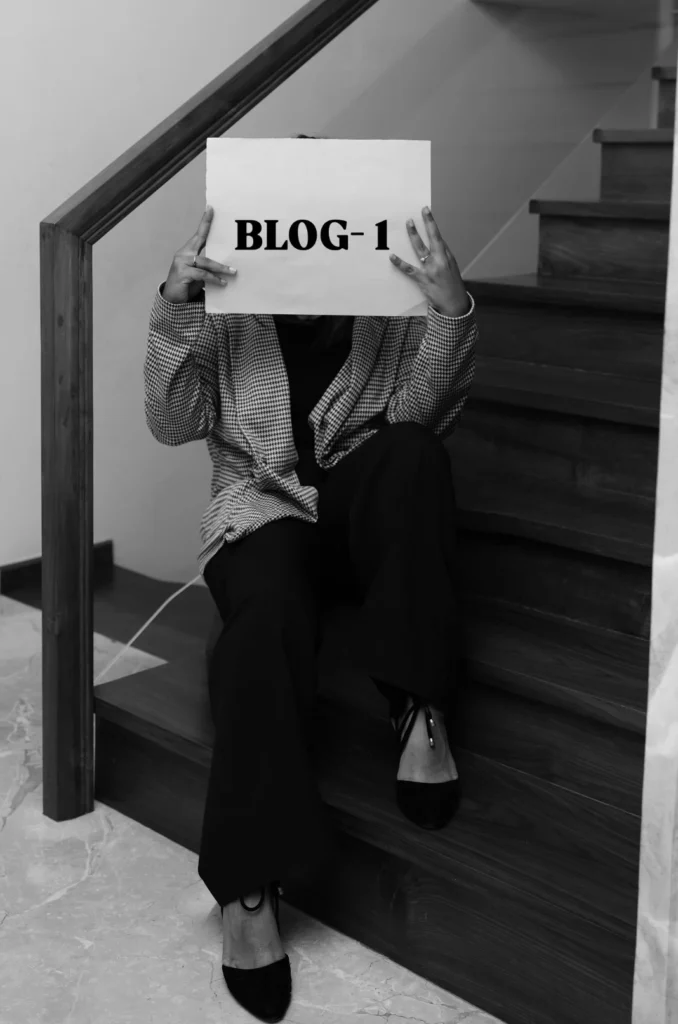 Black and white picture of holding a piece of paper that says "BLOG-1," acting as the best freelance digital marketing consultant in Dubai.