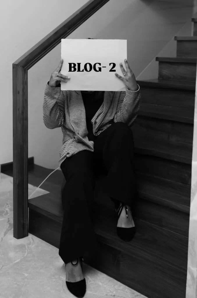 Black and white picture of holding a piece of paper that says "BLOG-2," acting as the best freelance digital marketing consultant in Dubai.