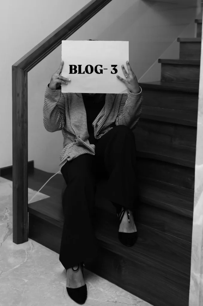 Black and white picture of holding a piece of paper that says "BLOG-3," acting as the best freelance digital marketing consultant in Dubai.